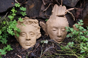 BACK TO THE EARTH - Terracotta - I decided not to finish these two heads so they are going back to the earth in the garden.  They are going the way of all things.